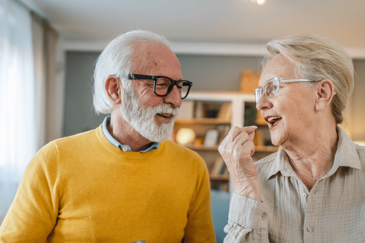 man and woman sitting together as the woman prepares to take her vitamins